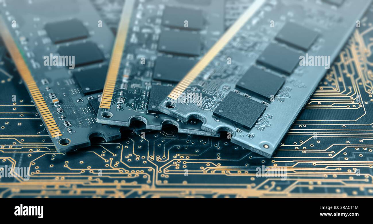 computer memory modules on background of black printed circuit board with golden wires Stock Photo