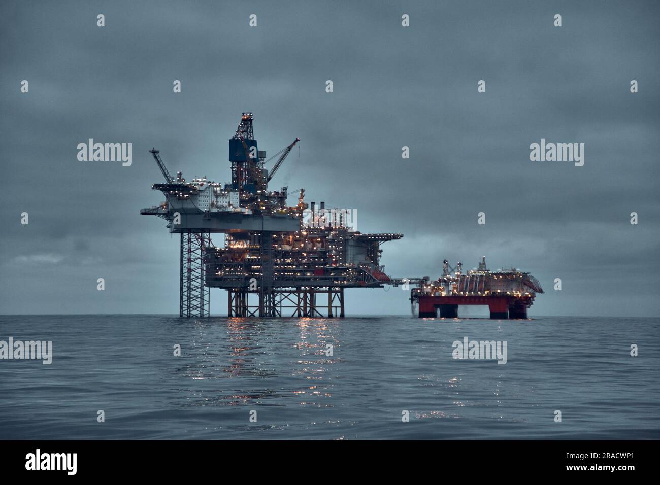 North Sea oil and gas production. Oil and gas platform, jack up rig in the sea at dusk with dark North Sea oil and gas production. Oil and gas platform, jack up rig in the sea at dusk with dark
