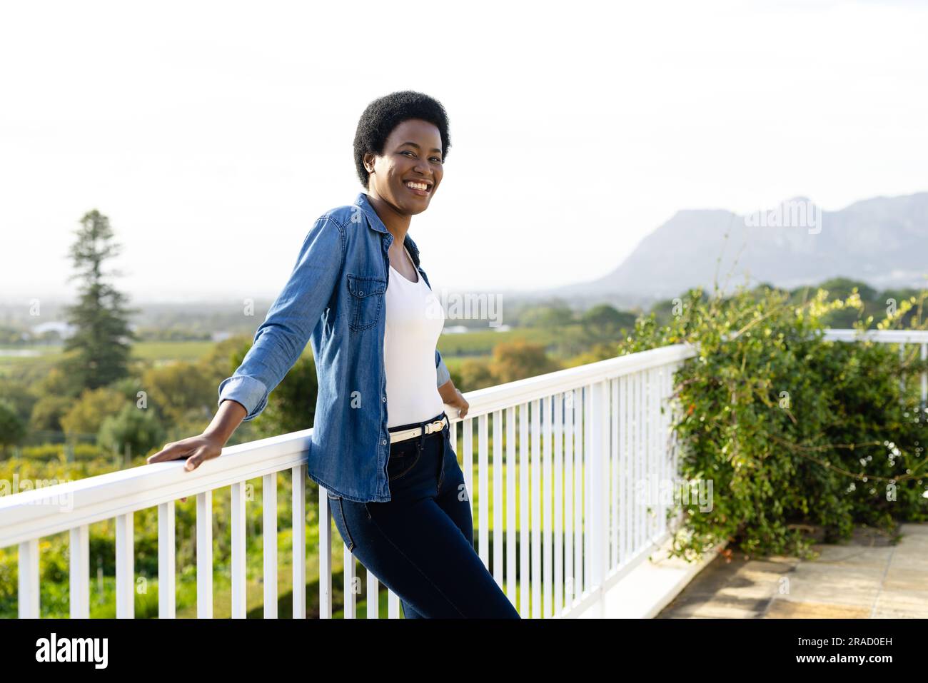 Portrait of happy african american woman staying on sunny terrace Stock ...