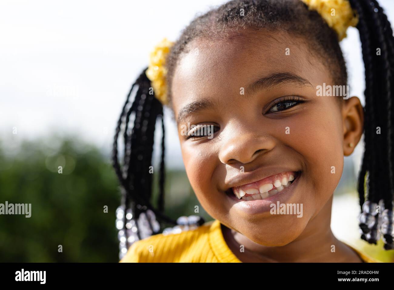 Close-up portrait of cute african american girl smiling at camera ...