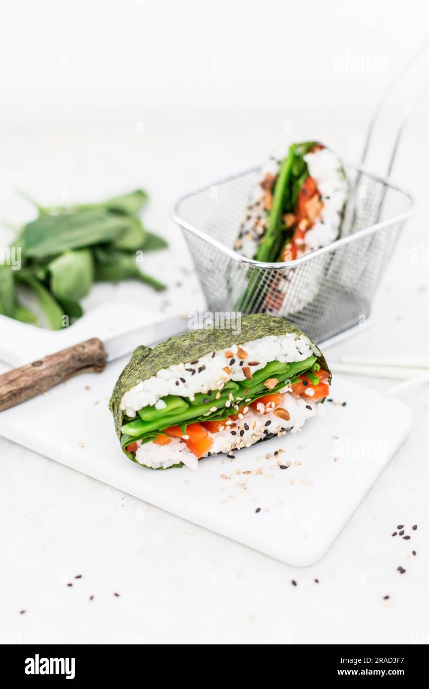 Sushi sandwiches with spinach, peppers, mange tout, black sesame seeds and peanuts (Japan Stock