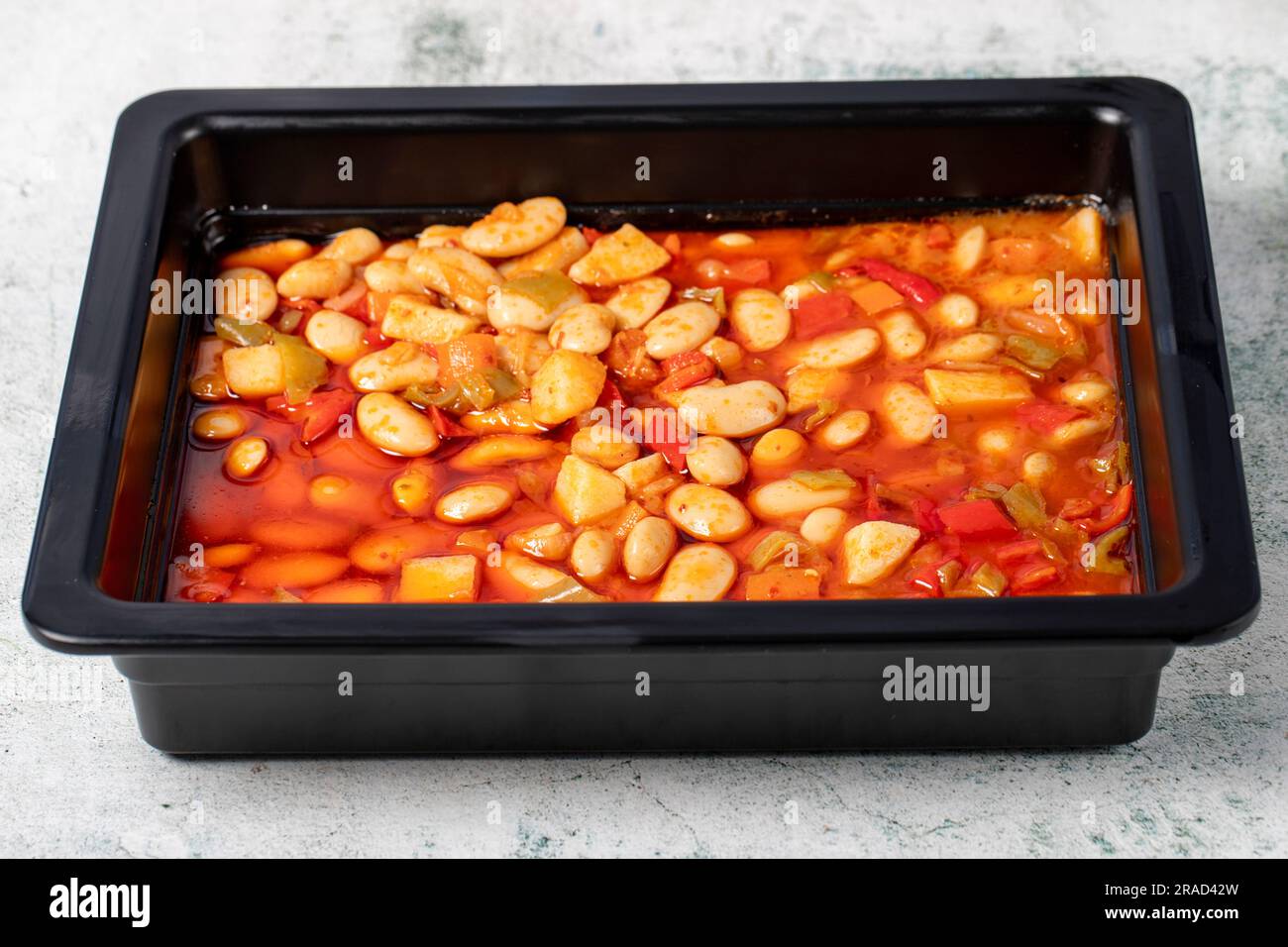 Bean dish with olive oil on gray background. Healthy appetizers. local name bombay fasıulye pilaki Stock Photo
