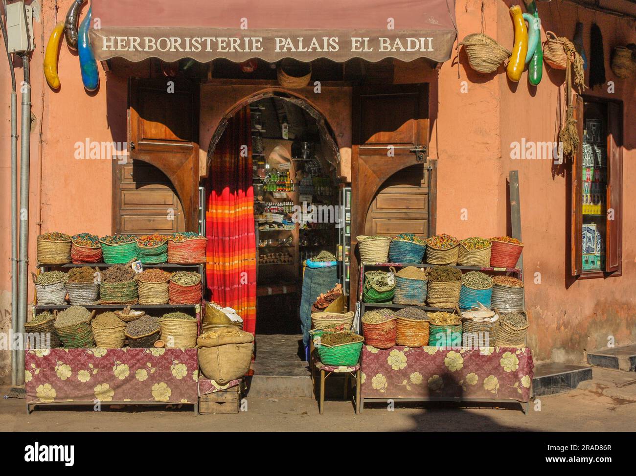 Facade herbal shop in Marrakech with different bags at the entrance Stock Photo