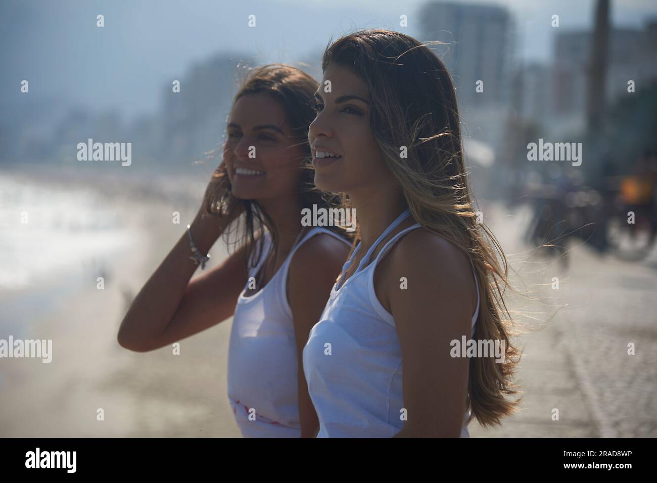 Portrait of two beautiful Brazilian models smiling at the beach in Rio Stock Photo