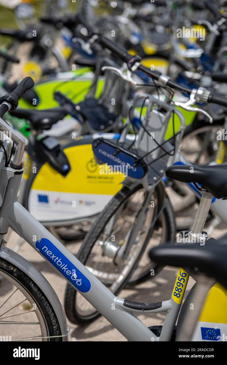 large quantity of e bikes for hire on a stand in grad split, croatia. electronic hire bikes ready for use on rental stand in city centre of split. Stock Photo