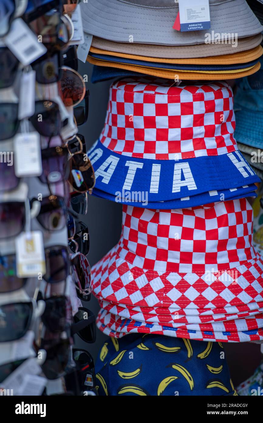 hats and sunglasses for sale at a market stall in grad split in croatia, croatian flag hats and sunglasses for tourists souvenirs Stock Photo