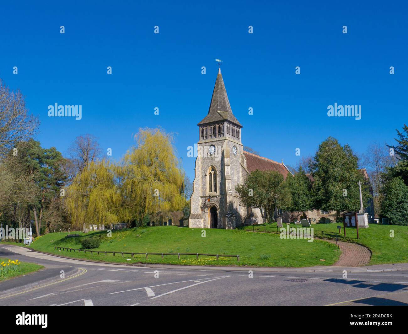 St Nicholas Church ,Wickham,Hampshire.The church is a striking example of a building on a large, almost circular, mound, which had probably been sacre Stock Photo