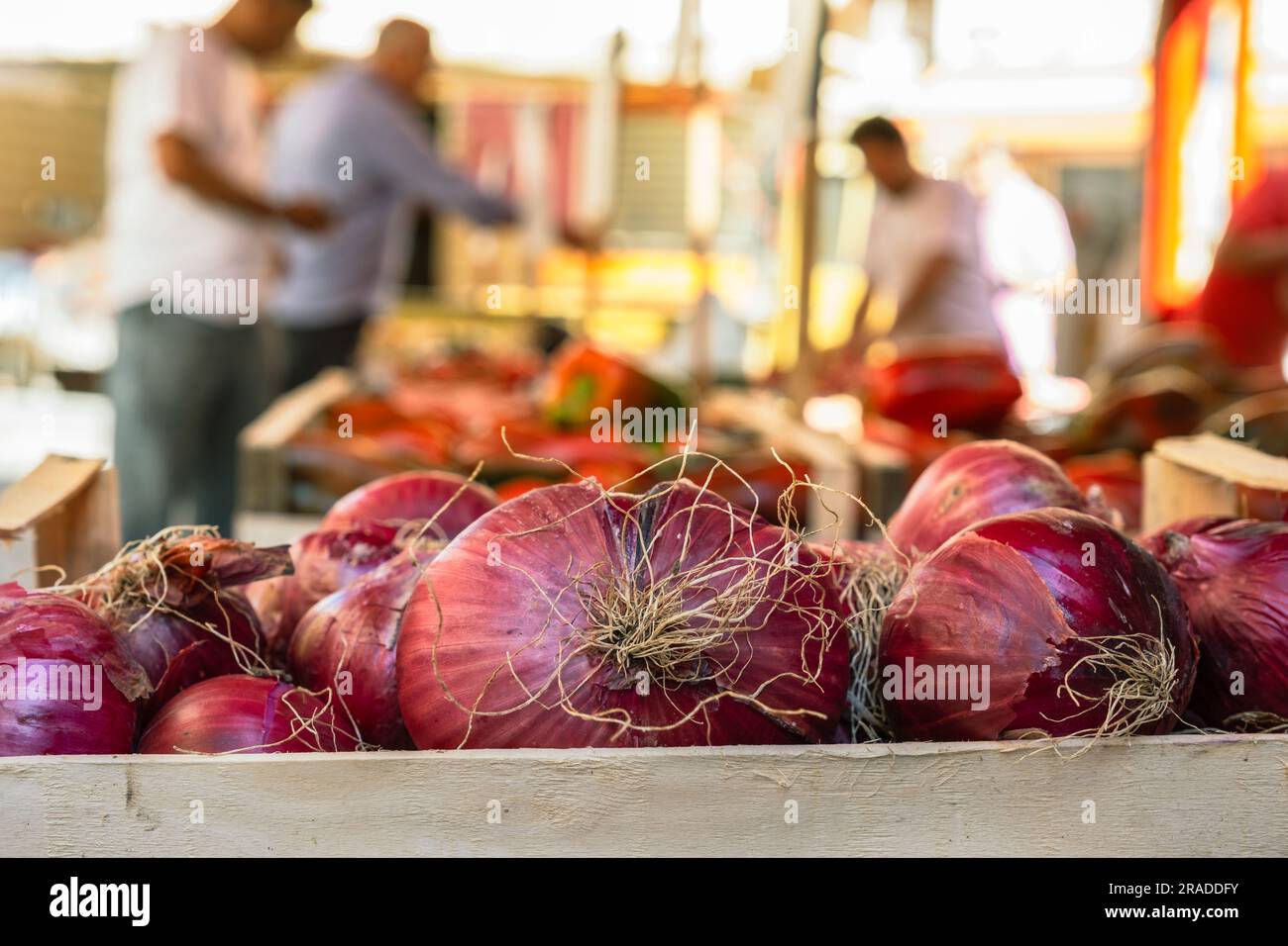 Red onion on a street food market Ballaro in Palermo Sicily, vegetable stand with blurred background Stock Photo