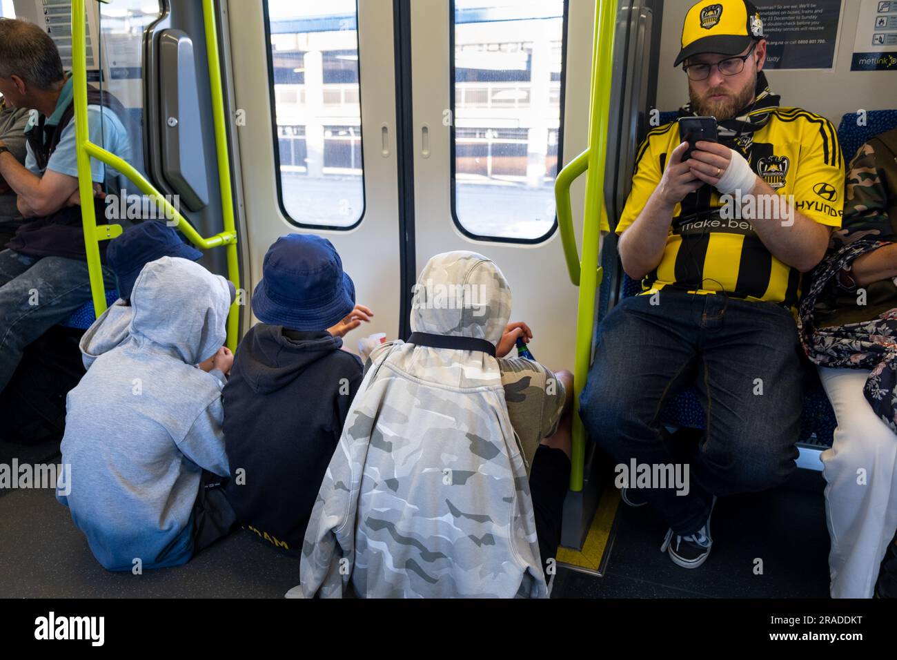 Sport fans head home on a city train after Wellington Phoenix FC v Sydney FC in the A-League at Wellington Regional Stadium in Wellington, New Zealand Stock Photo