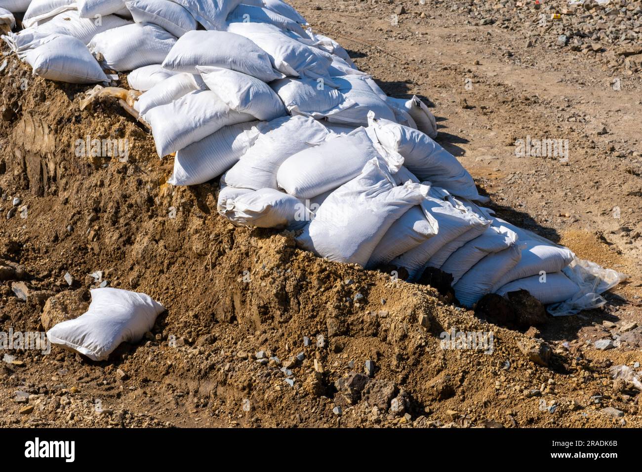 A bunch of bags with cement, sand outside. Material for building
