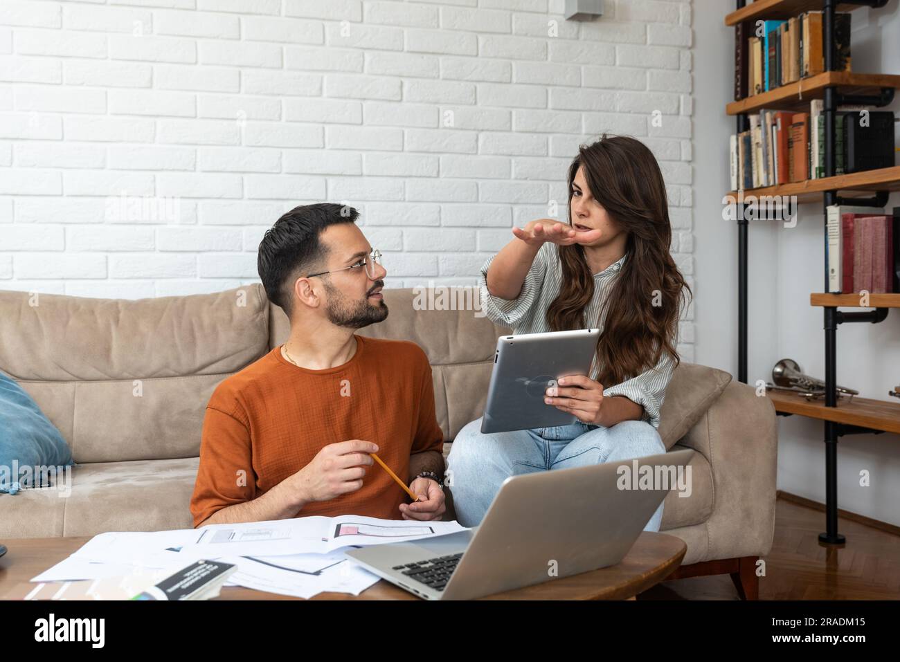 Using Computer With Partner Young smart couple business owners and partners architectural exterior ...