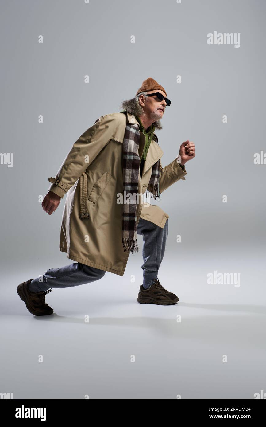full length of grey haired man in dark sunglasses and hipster style ...