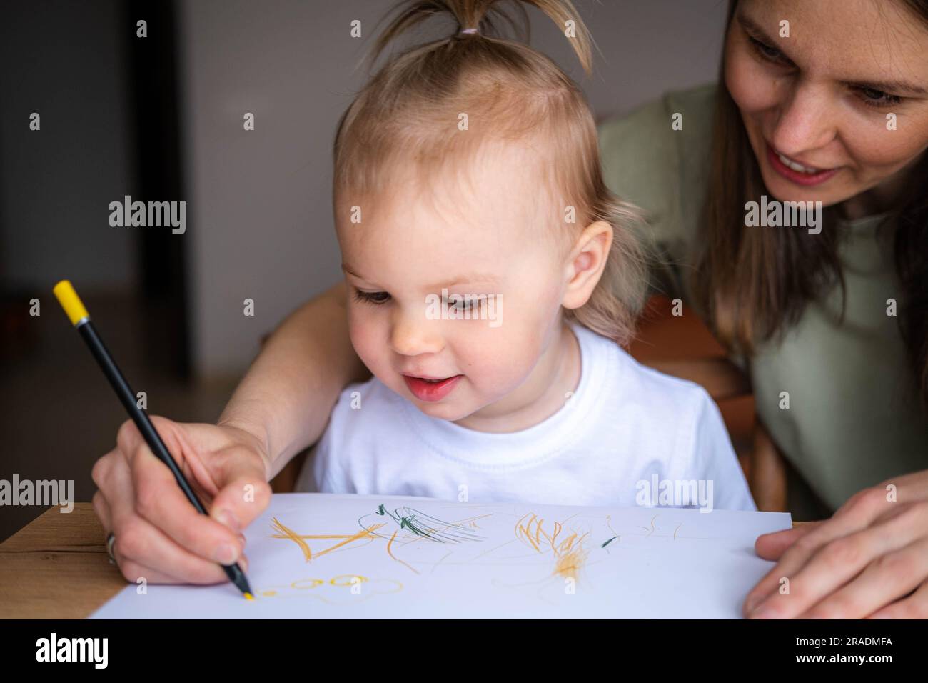 mother teach daughter girl paint or writing use album and colourful ...