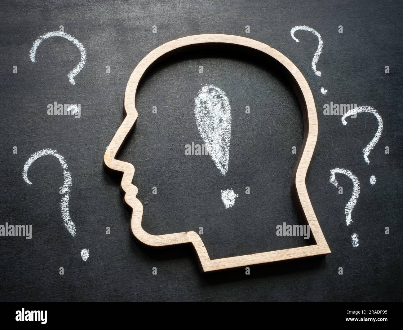 The contour of the head and the exclamation mark inside as a symbol of answering questions. Stock Photo