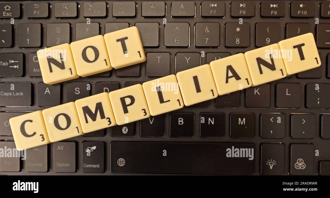 Not Compliant in Scrabble letters on a computer keyboard Stock Photo