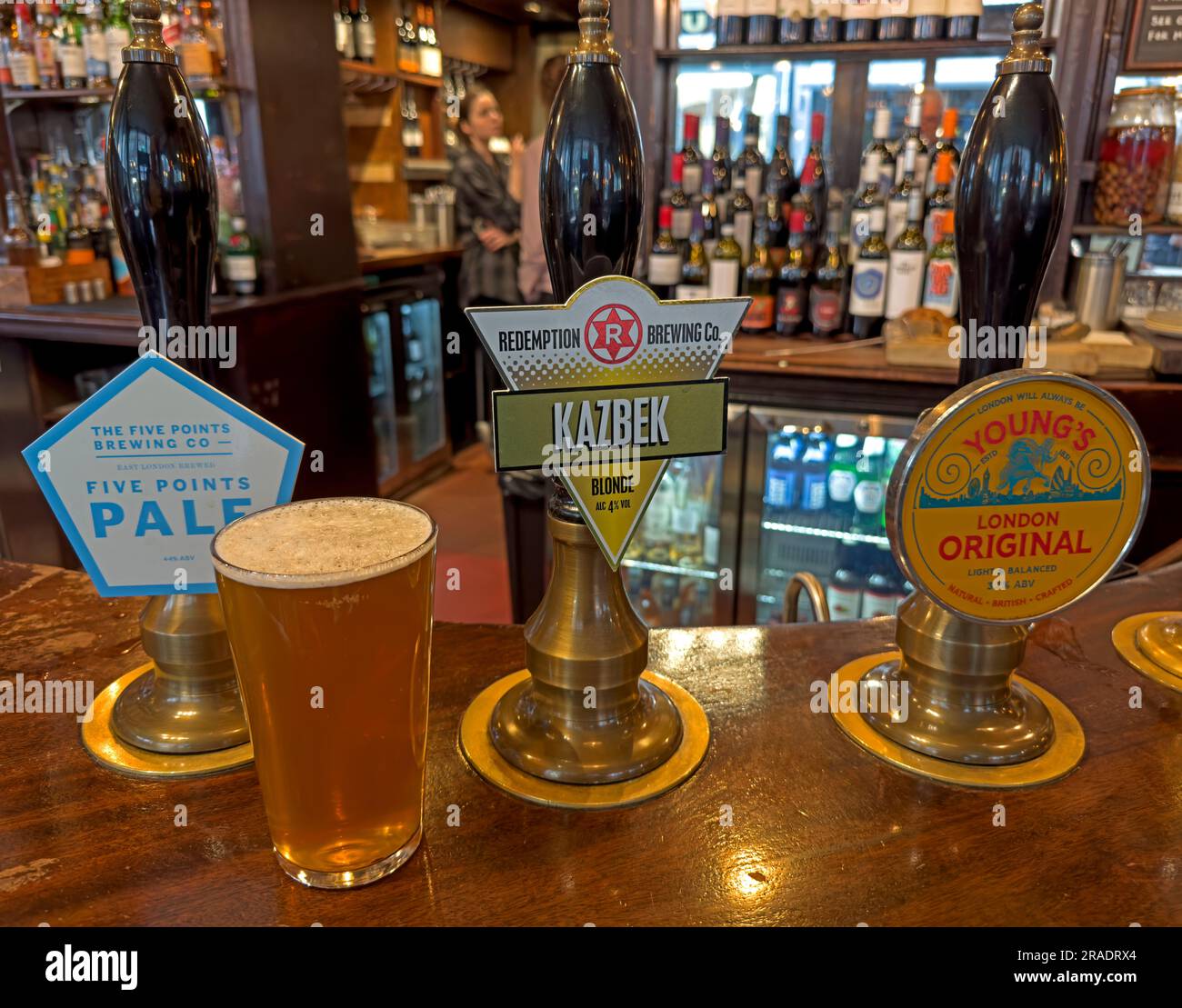 Selection of London ales on the bar, including Five Points Pale, Kazbek from Redemption Brewing Company, and Young’s London Original, served in a pub Stock Photo