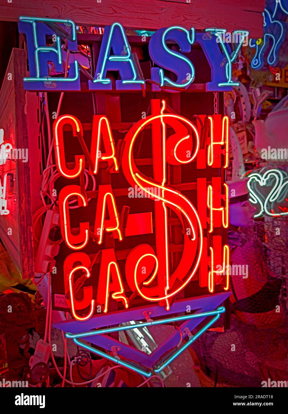 Easy cash in neon lights - red and blue - Easy money - become a Bitcoin investor, taking the opportunity to be rich gambling or investing Stock Photo
