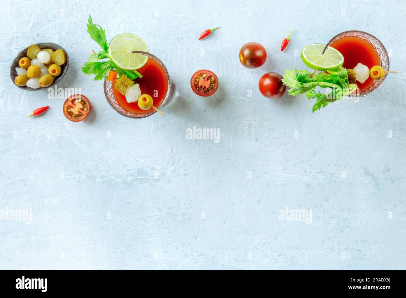 https://c8.alamy.com/comp/2RADX8J/bloody-mary-cocktail-with-garnish-shot-from-above-with-copy-space-spicy-tomato-juice-with-alcohol-lime-pickles-celery-2RADX8J.jpg