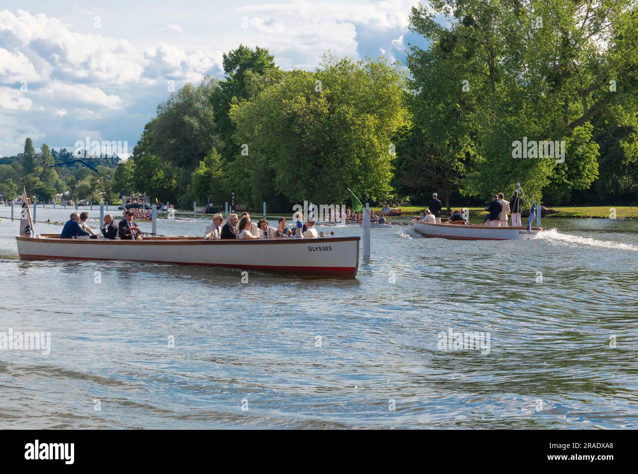 HRR Umpire's Launch on route to the start at Temple Island for the next race waits to cross rowing lane after current  race passes- by., Stock Photo