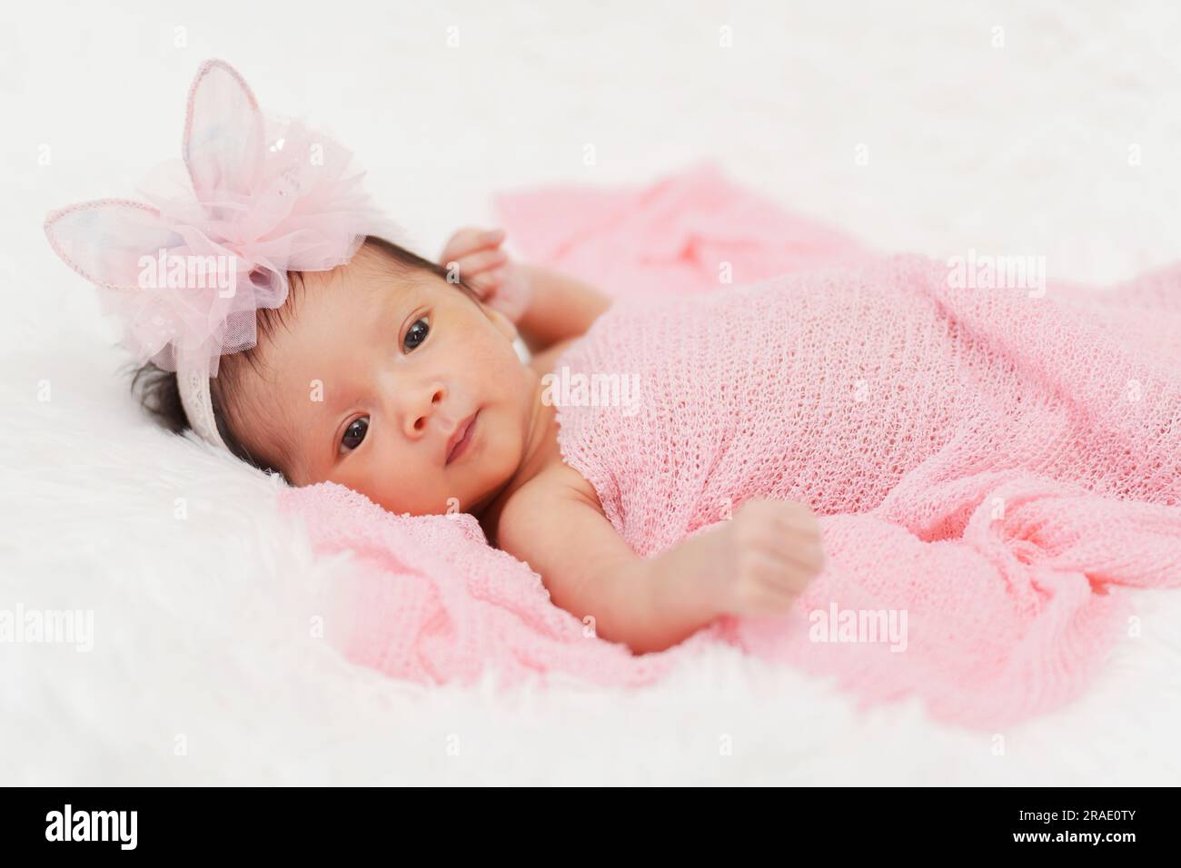 newborn baby girl in blanket on a bed Stock Photo Alamy