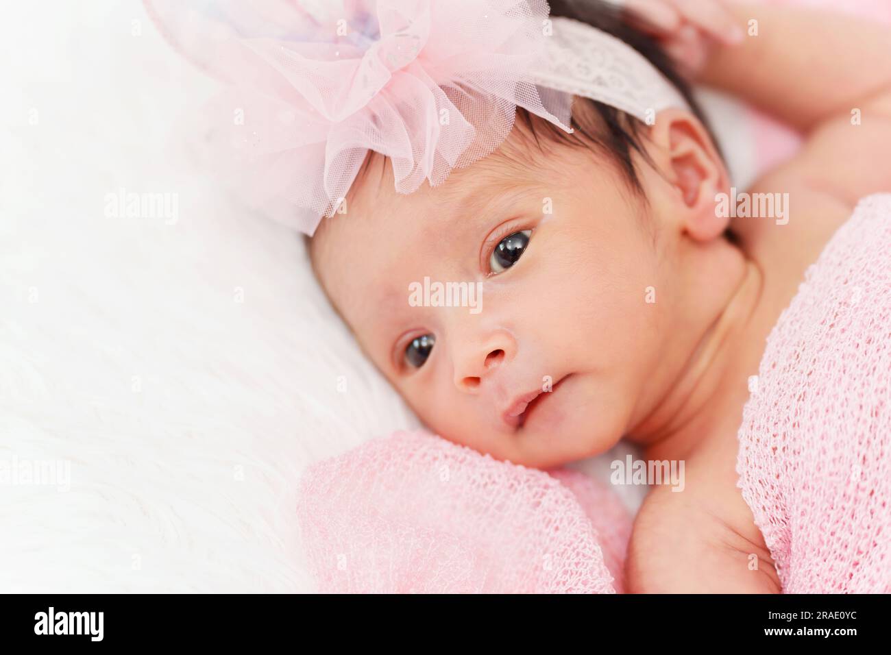 newborn baby girl in blanket on a bed Stock Photo Alamy
