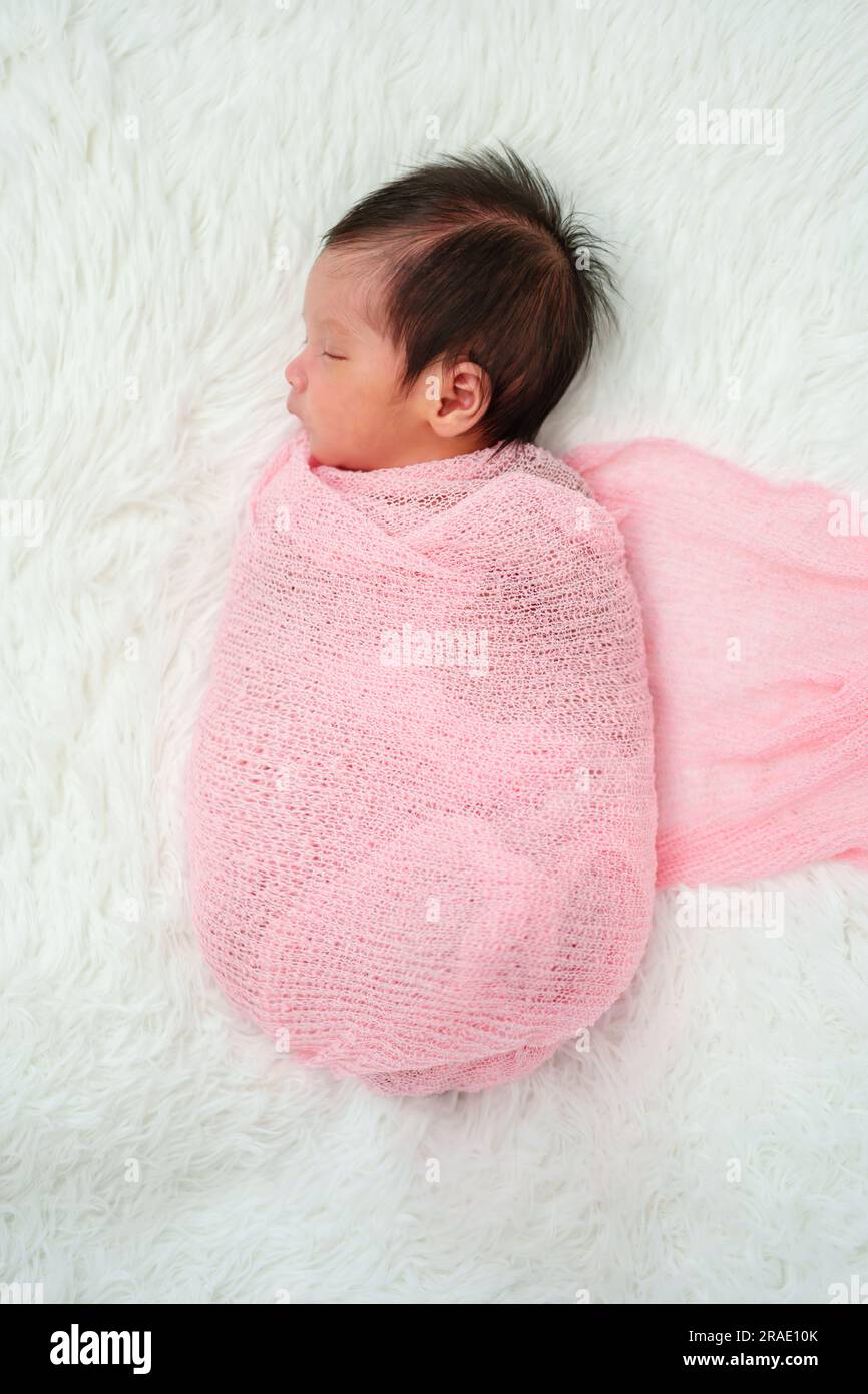 newborn baby sleep in cloth wrap blanket on a bed Stock Photo Alamy