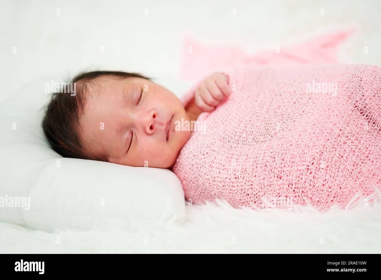 newborn baby sleep in cloth wrap blanket on a bed Stock Photo Alamy