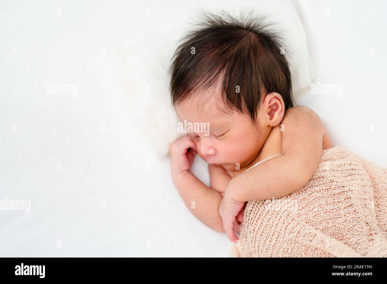 newborn baby sleep in cloth wrap blanket on a bed Stock Photo Alamy