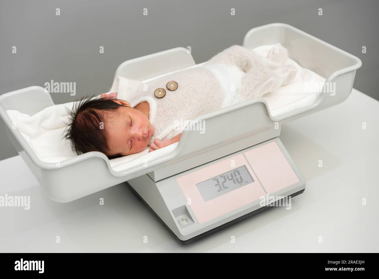 Newborn Baby On Weighing Scale Stock Photo, Picture and Royalty Free Image.  Image 24134897.