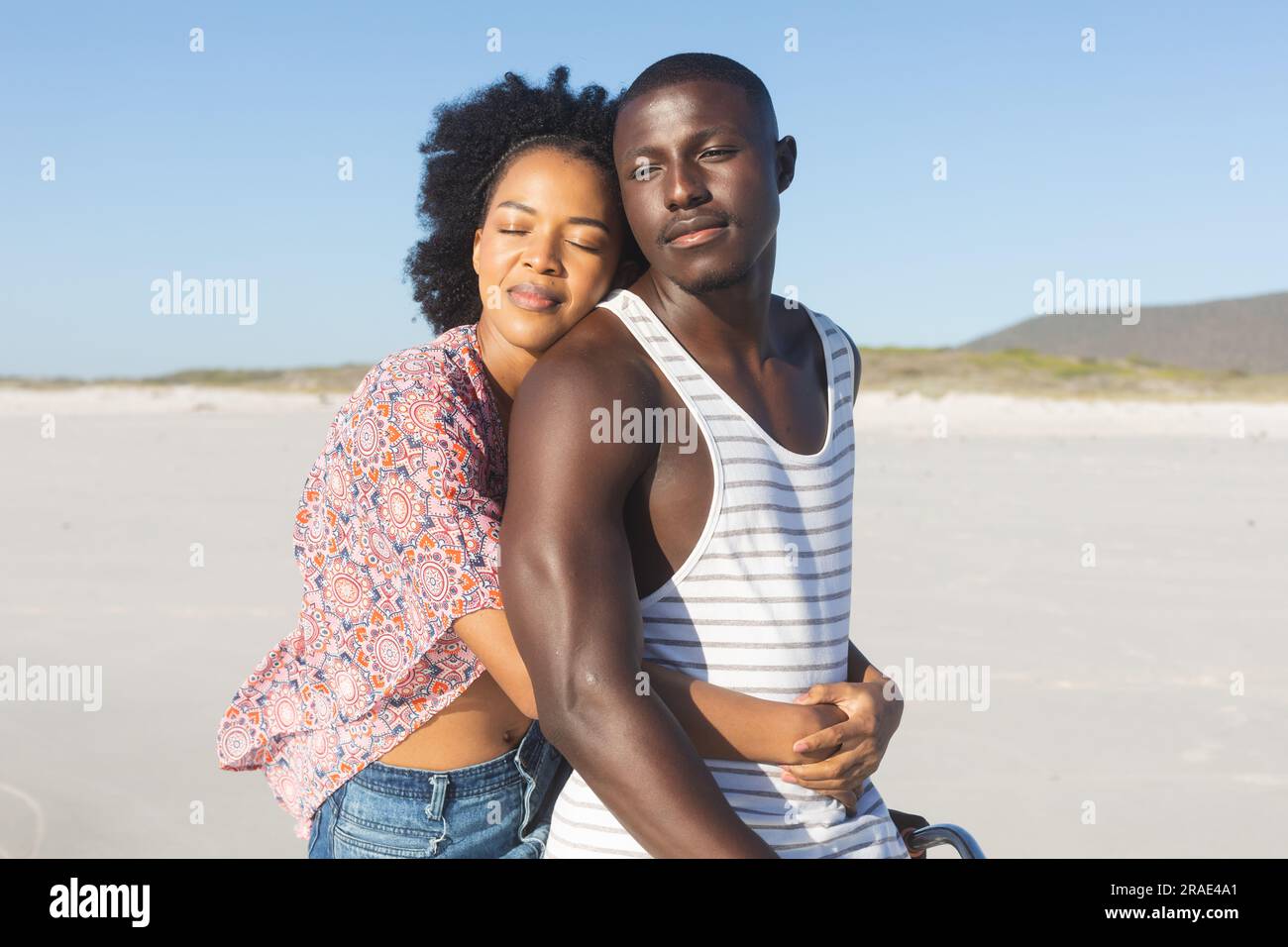 Happy african american couple embracing and smiling with eyes closed on ...