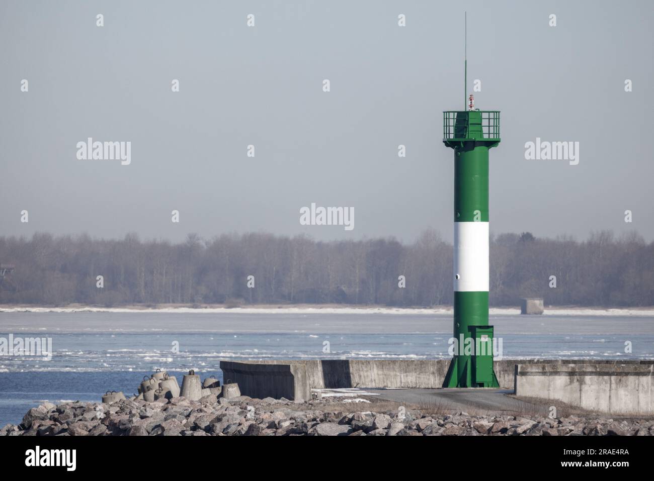 Coastal navigation mark, striped green white lighthouse tower Stock Photo