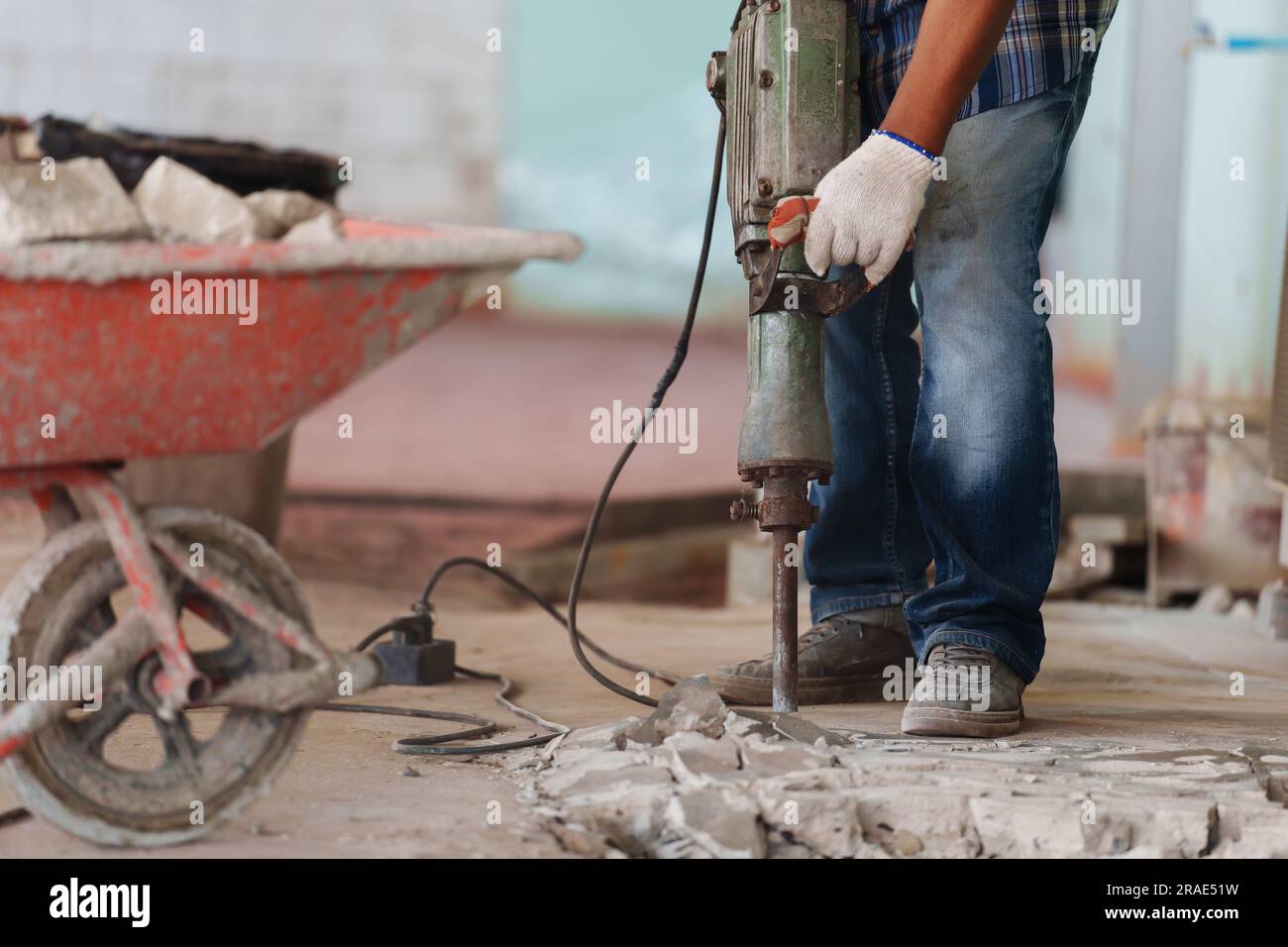 labor using a jackhammer to break up a concrete floor Stock Photo Alamy