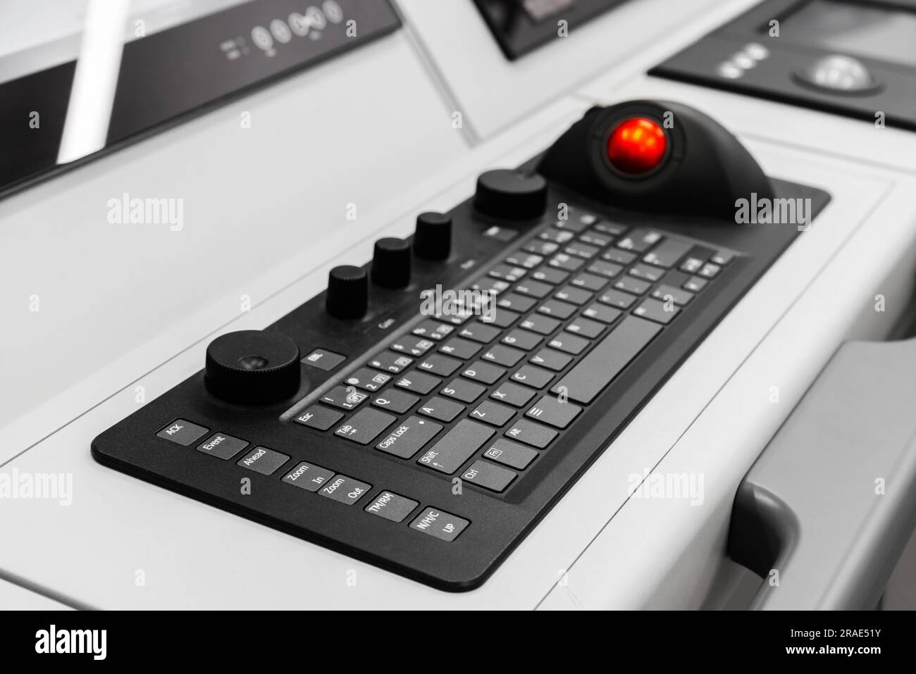 Built-in tabletop input device, industrial keyboard with trackball mouse, modern navigation equipment mounted on a captains bridge Stock Photo