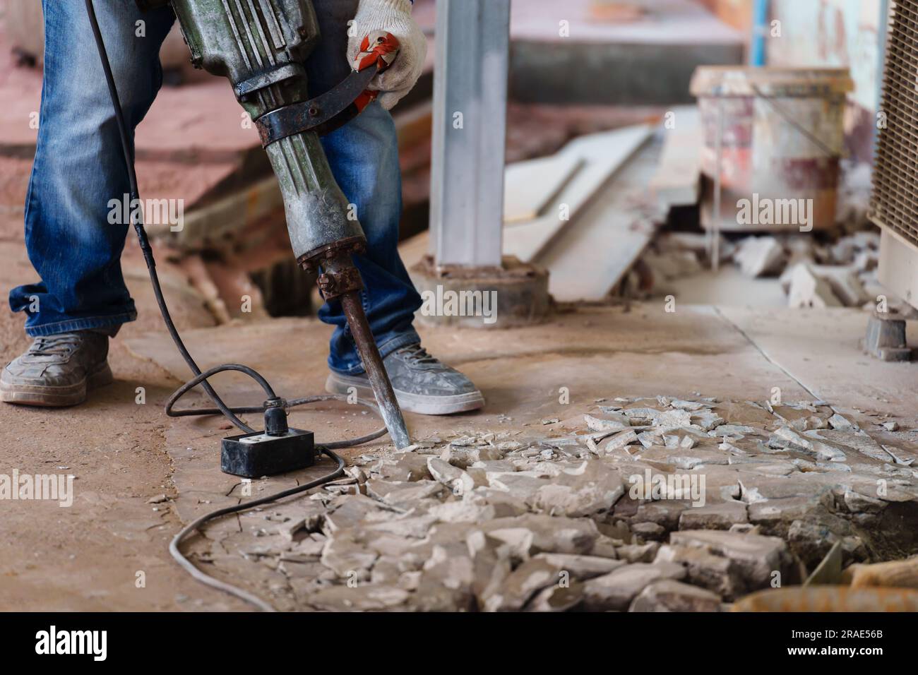 labor using a jackhammer to break up a concrete floor Stock Photo Alamy