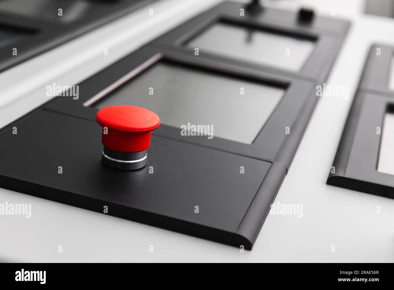 Red button and sensor screens on a modern ship control panel, captain bridge equipment. Close-up photo with selective focus Stock Photo