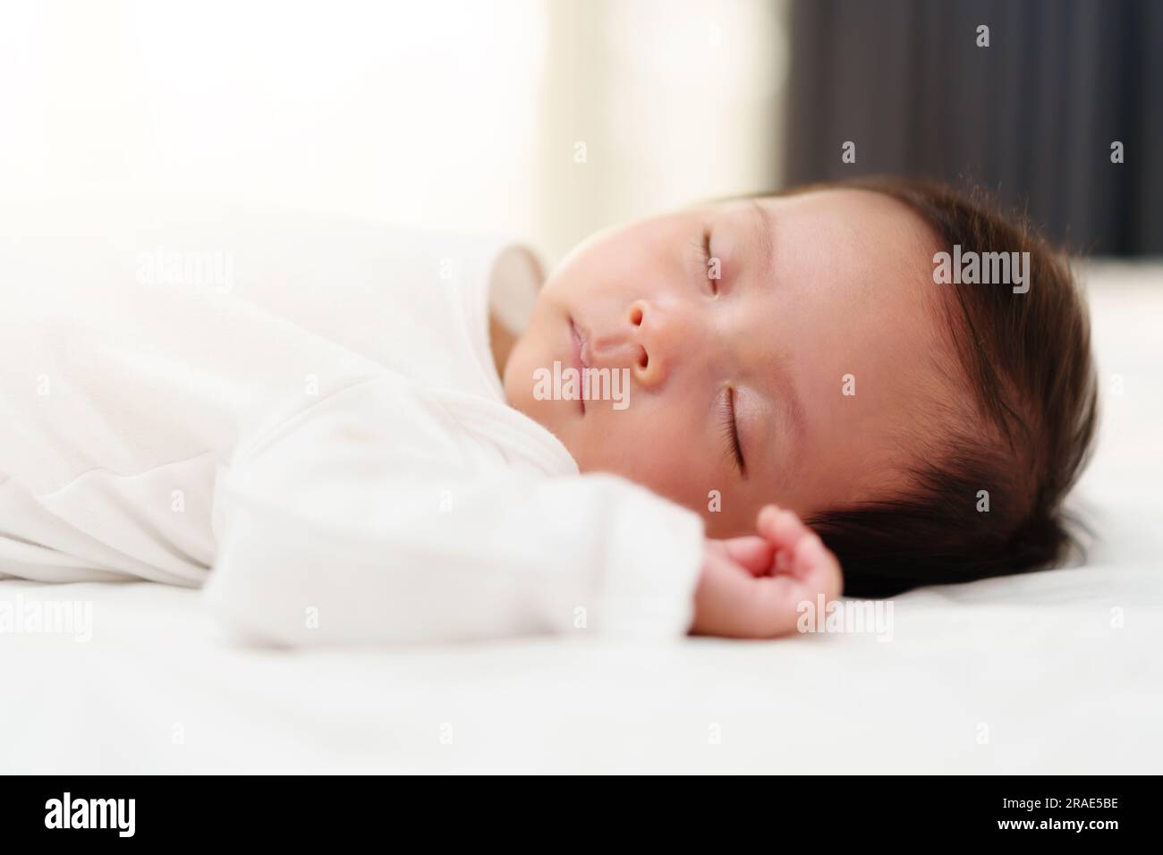 newborn baby sleeping on a bed Stock Photo Alamy