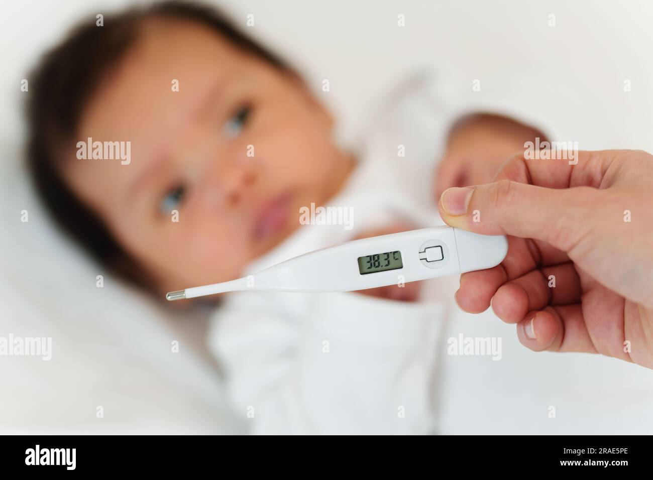 mother measuring temperature of her ill baby. sick child with high