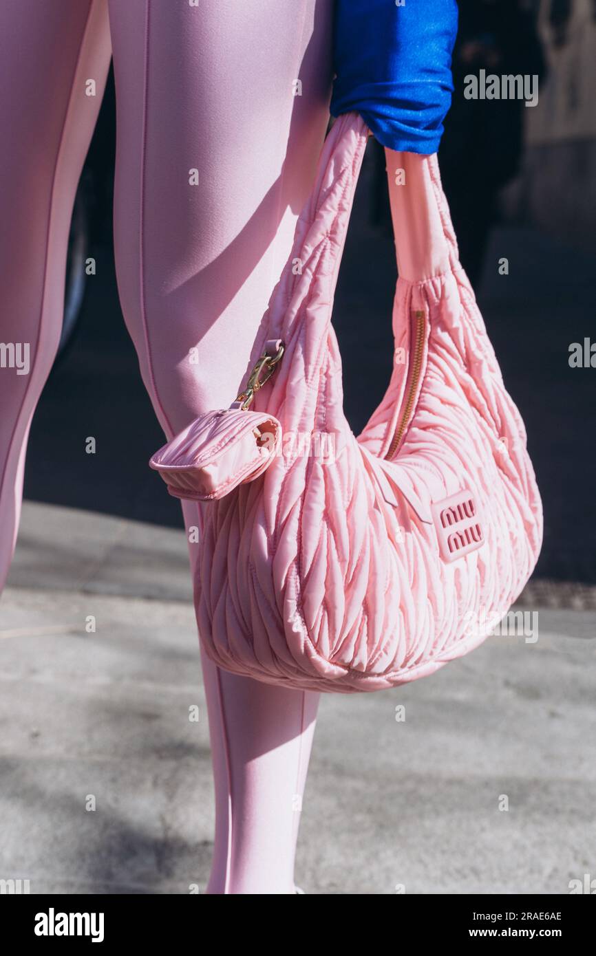 Milan, Italy - February, 25, 2022: woman wears pink Miu Miu Wander  Matelasse hobo bag in regenerated nylon Stock Photo - Alamy