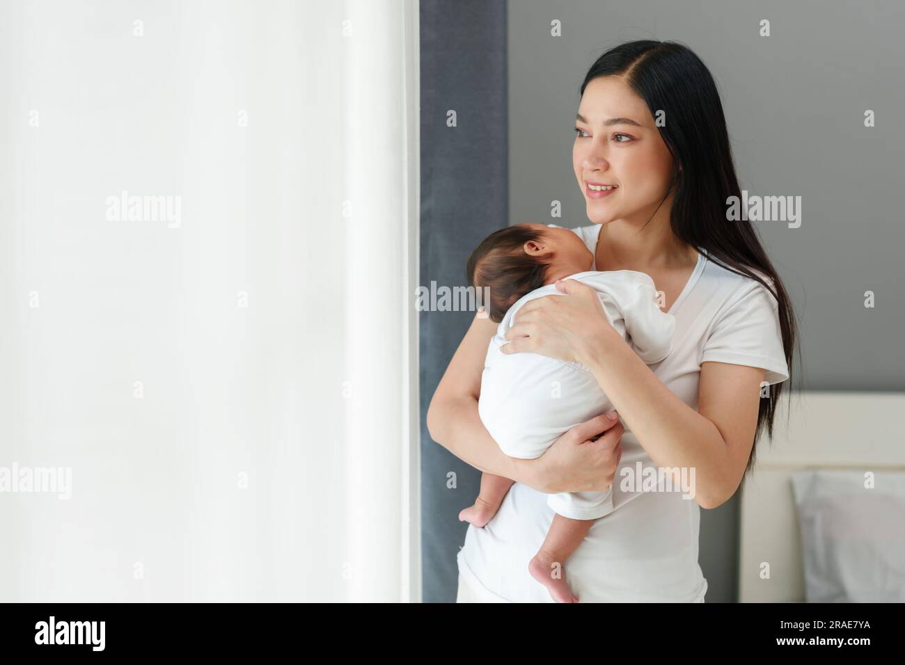 mother holding and consoling her newborn baby to sleeping near the