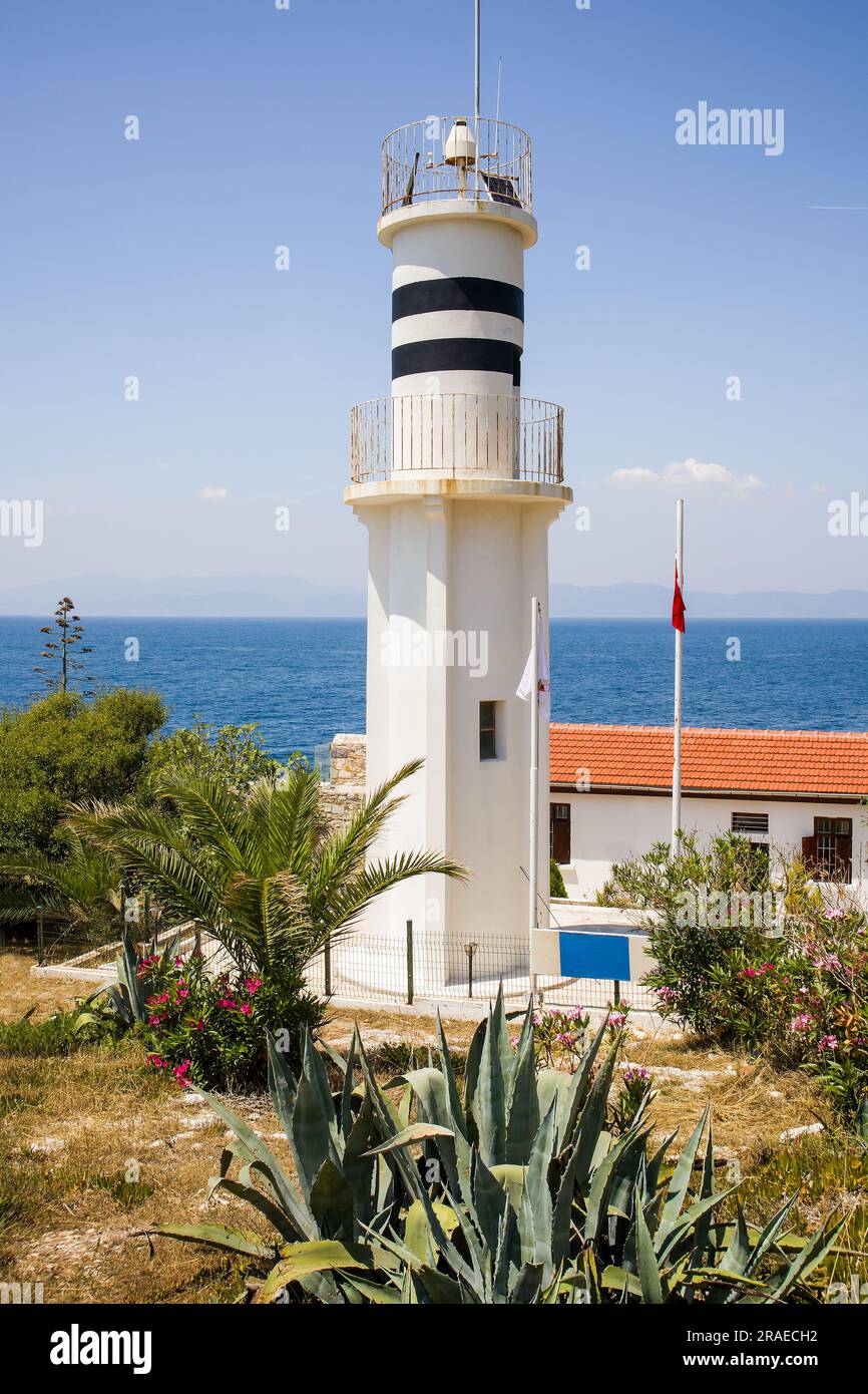 A white lighthouse on the island of Güverginada in Kusadasi, Aydin city of Turkey. Stock Photo