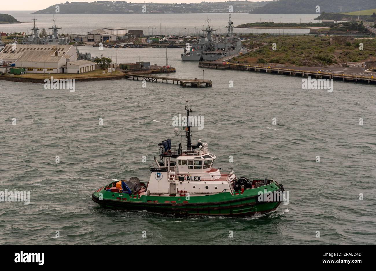 Cobh, Ireland, EU.  9 June 2023.  Alex an escort tug underway on Cobh Harbour with a background of Haulbowline Island and the naval. service base. Stock Photo