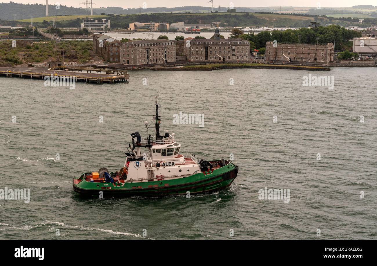 Cobh, Ireland, EU.  9 June 2023.  Alex an escort tug underway on Cobh Harbour with a background of Haulbowline Island and the naval. service base. Stock Photo