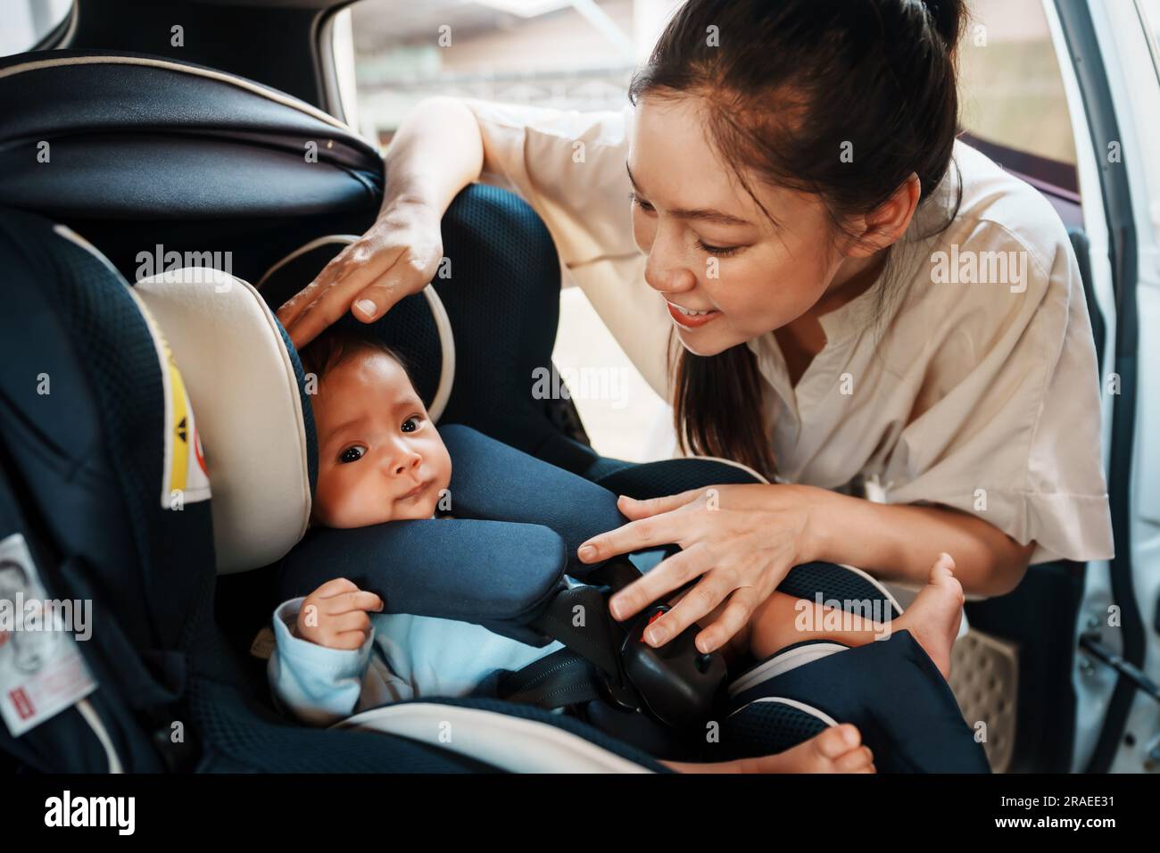 mother take care her newborn baby in the car seat Stock Photo Alamy