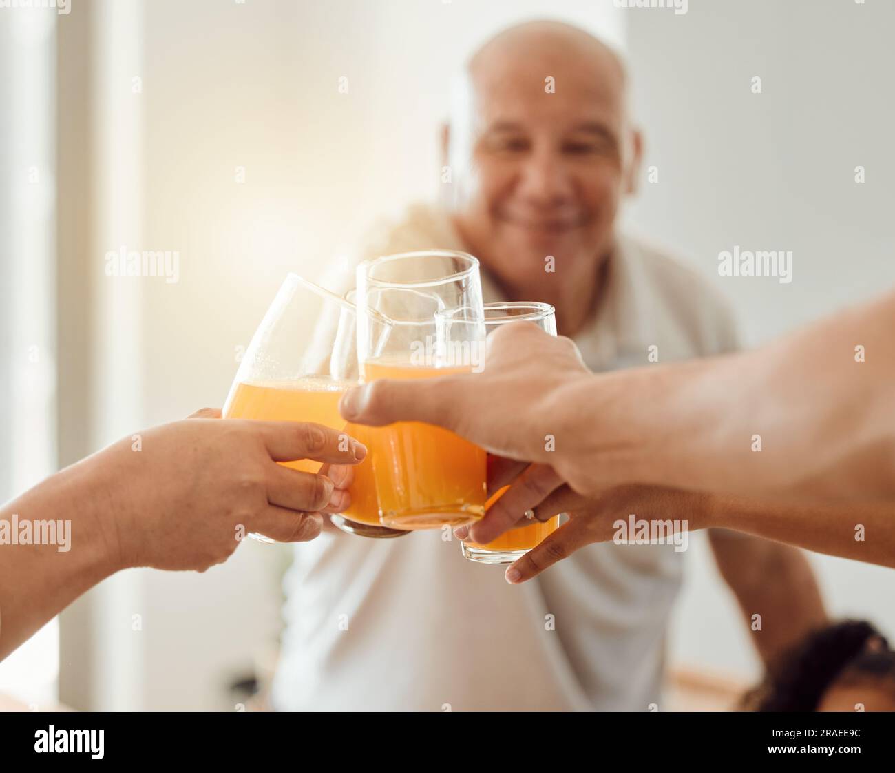 Celebration, senior happy man or toast with orange juice, beverage or glass drinks for fun friends reunion. Fruit liquid, retirement party group or Stock Photo