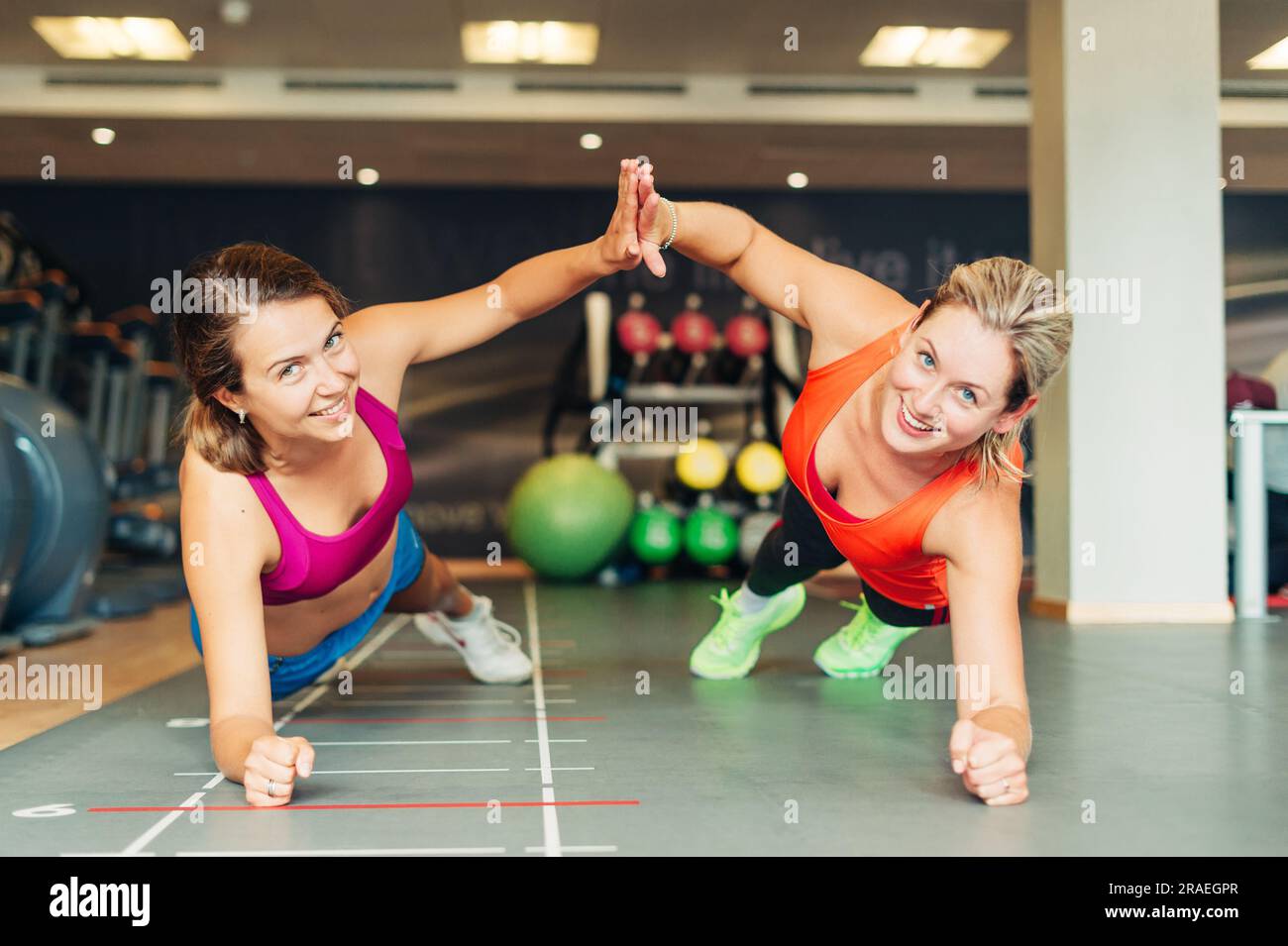 Young fit women working together in gym club Stock Photo