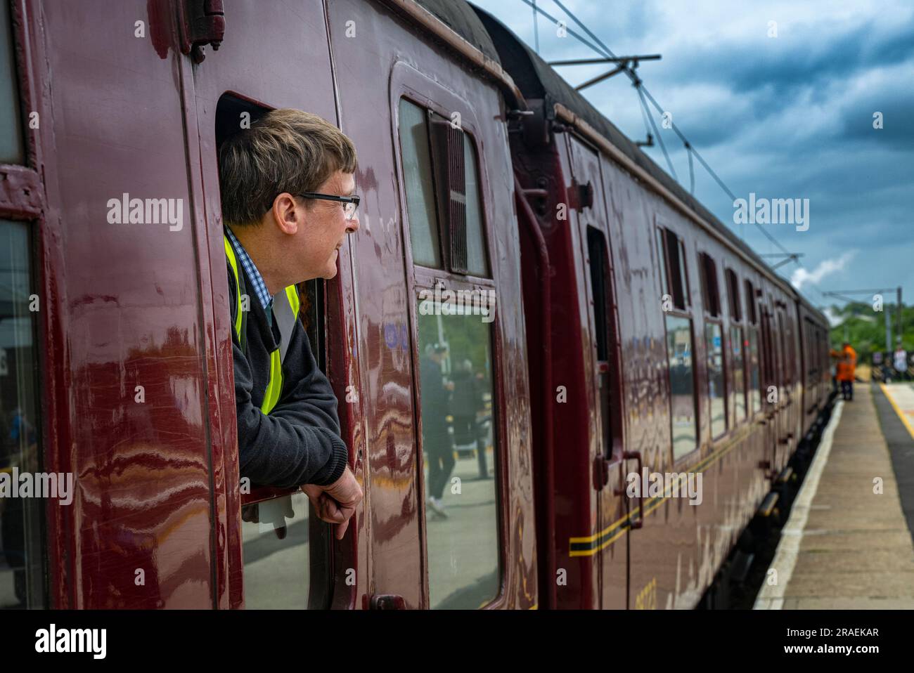 Portrait of the train guard of The Flying Scotsman steam train in Grantham station as it travels
