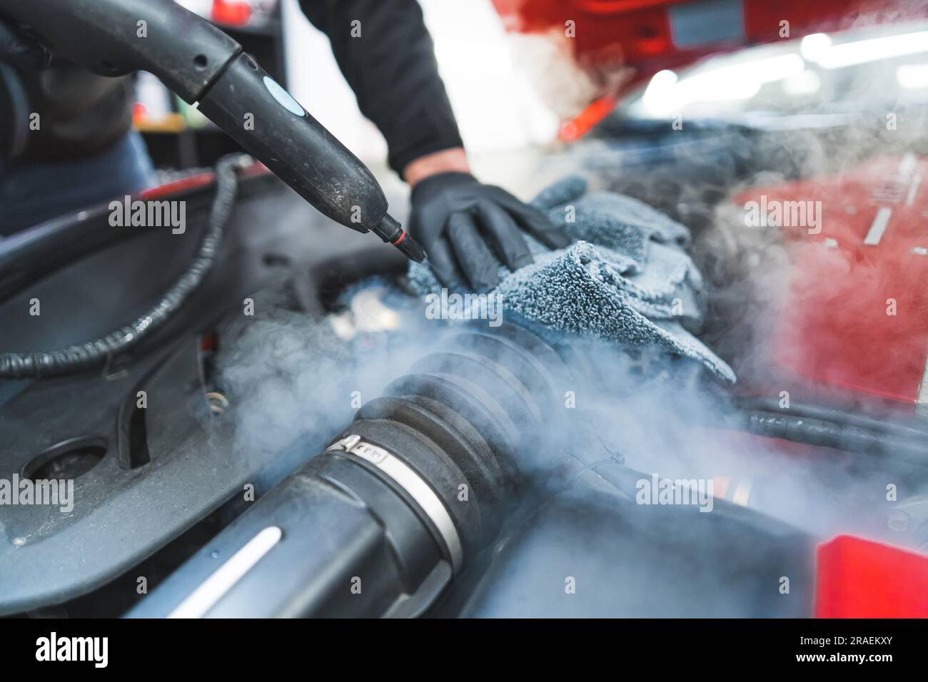 Closeup shot of car detailing process. Car washing cleaning engine. Cleaning car using steam. Steam engine washing. . High quality photo Stock Photo