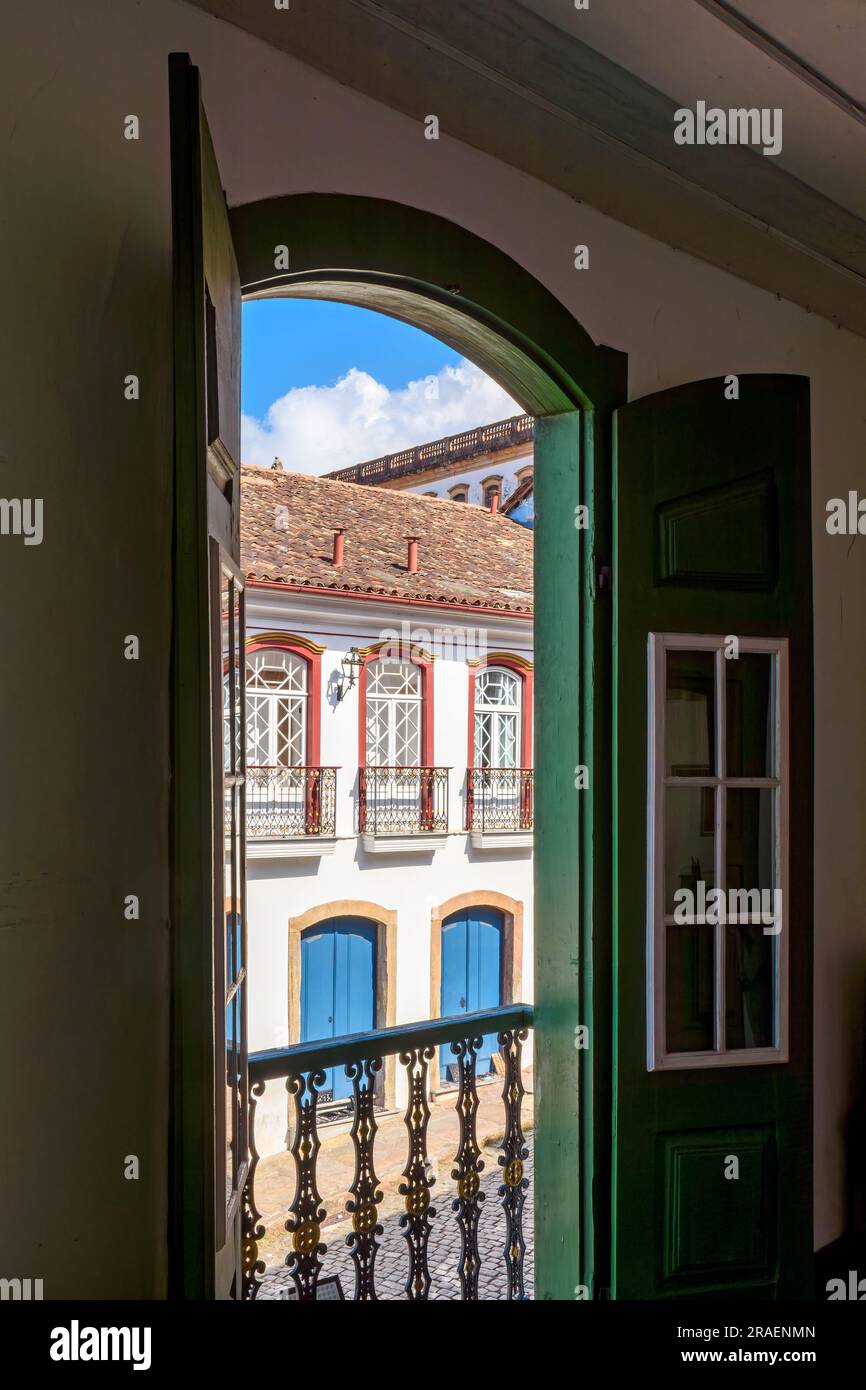 Historic city of Ouro Preto houses seen through the doors of a typical old colonial style house on state of Minas Gerais, Brazil Stock Photo