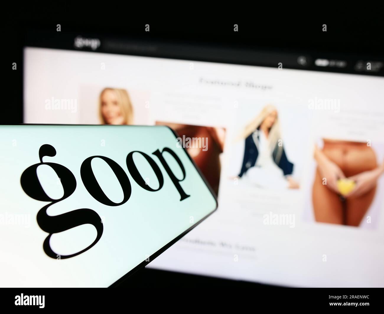 Mobile phone with logo of US publishing and e-commerce company Goop Inc. on screen in front of website. Focus on center-left of phone display. Stock Photo