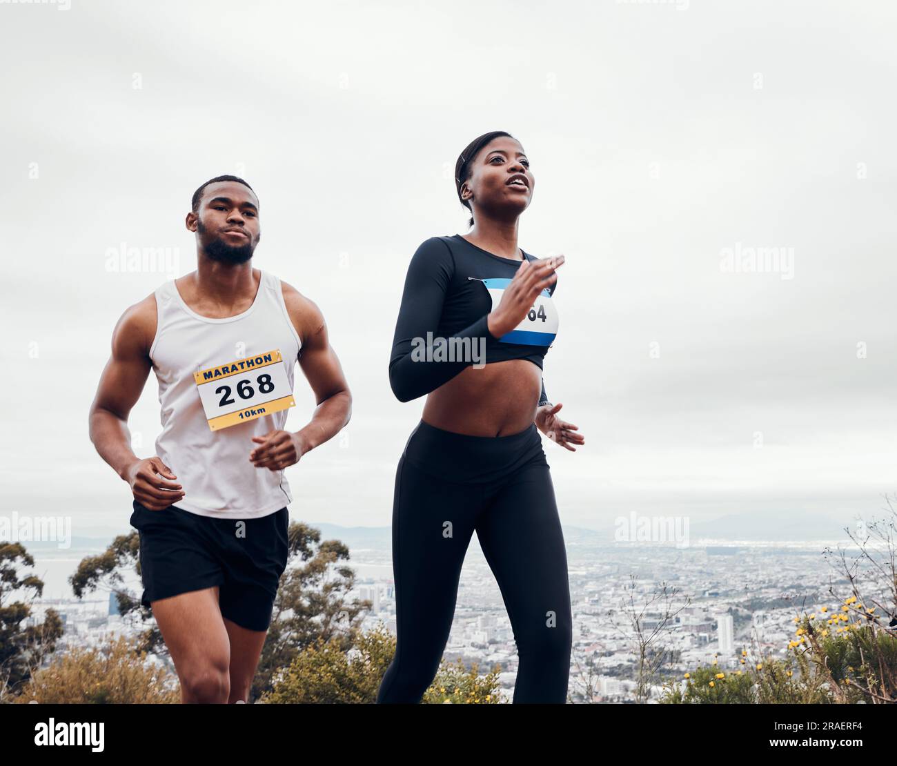 Running couple, mountain race and wellness with workout and training together for a marathon. Runner, young people and road on a exercise challenge Stock Photo
